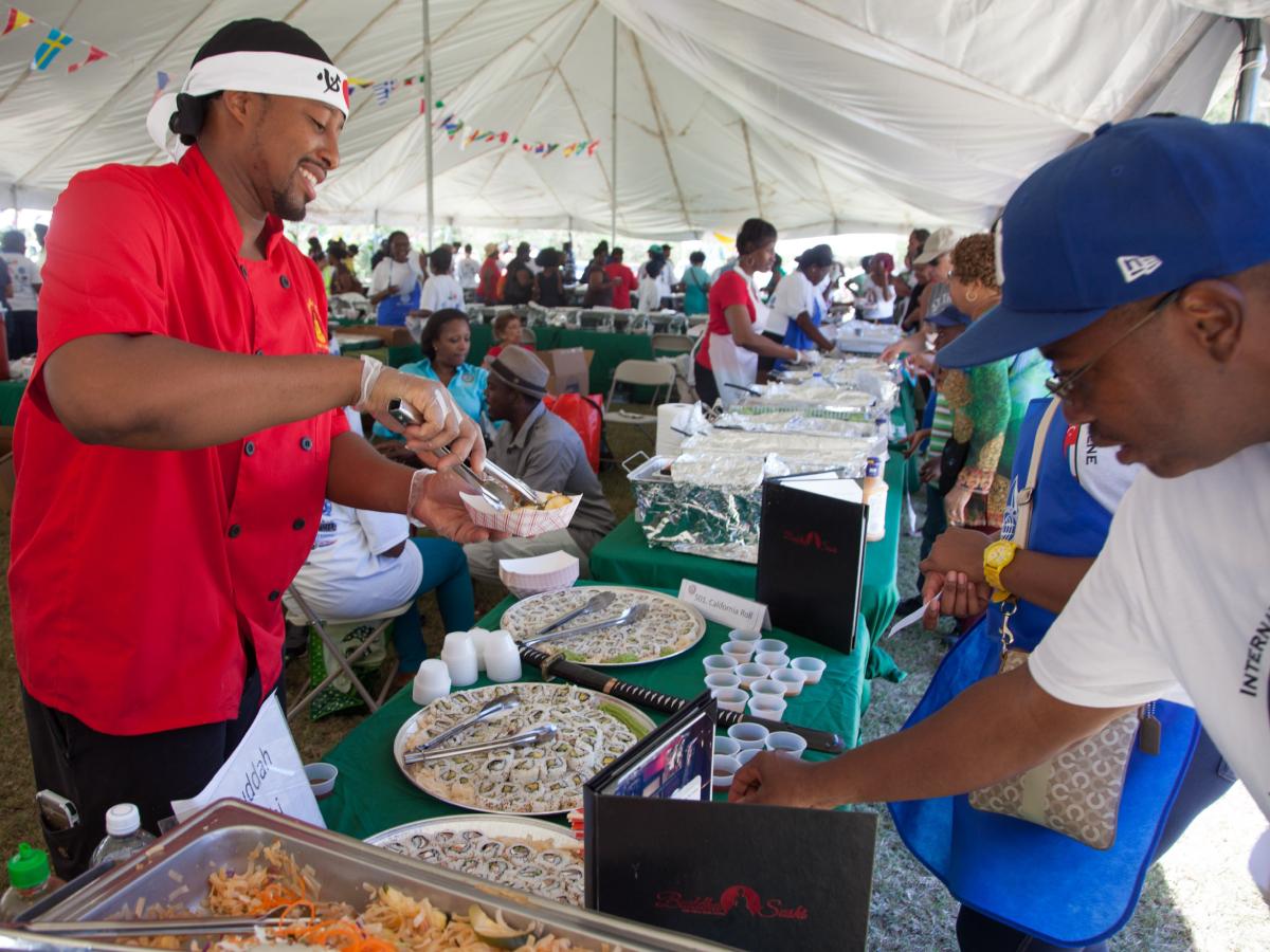 Chef Taj serves a dish at Afternoon on the Green