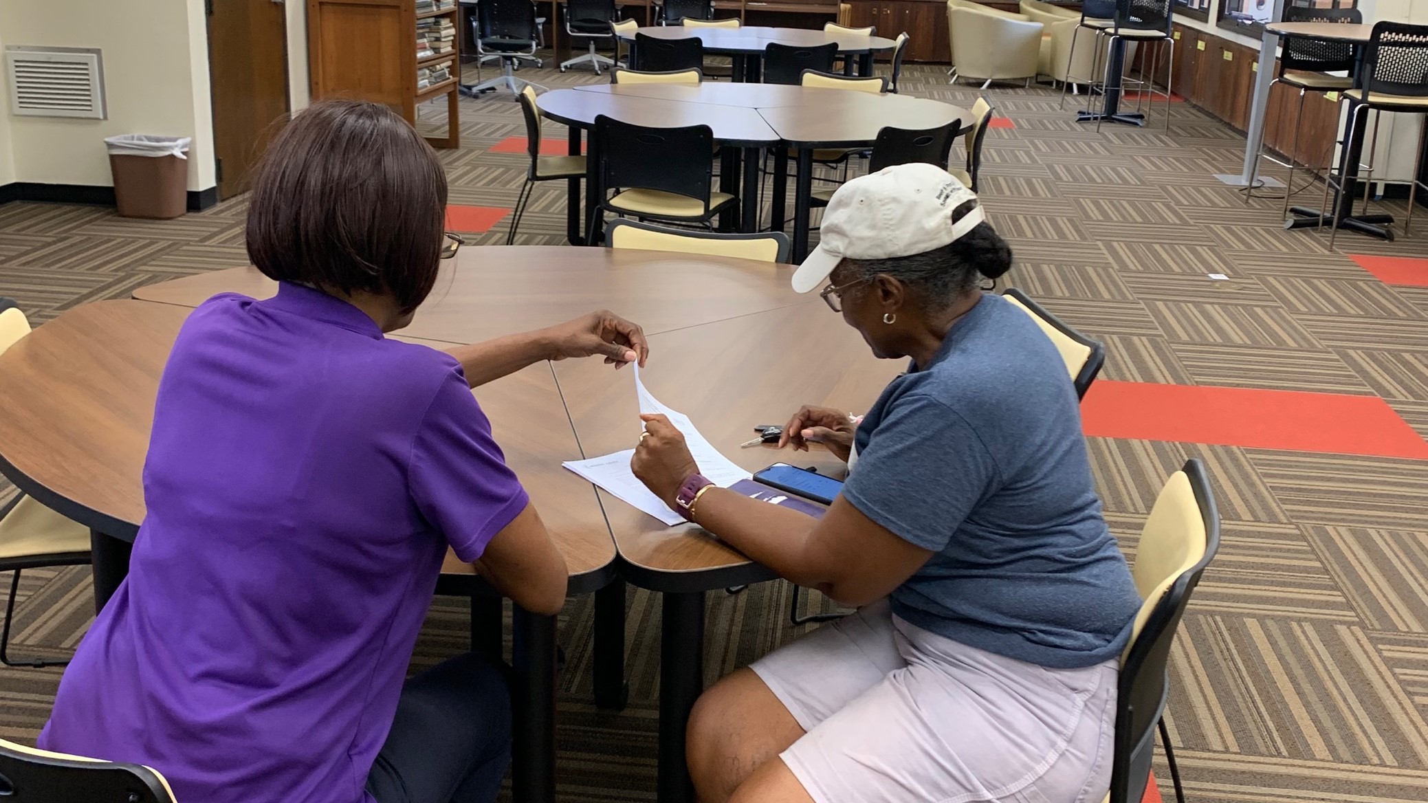 Librarian, Janice Simon, works with a community member.